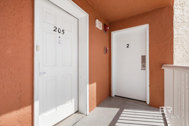 view of exterior entry with stucco siding