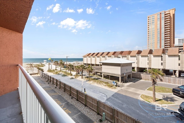 balcony with view of water and beach