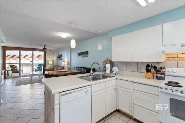 kitchen with white appliances, range hood, a sink, open floor plan, and a peninsula