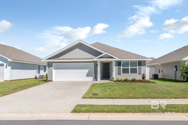 view of front facade with a garage, a front lawn, and central AC unit