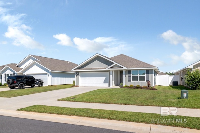 view of front of home with a front yard and a garage