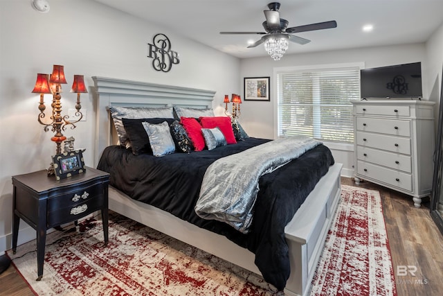 bedroom featuring ceiling fan and dark hardwood / wood-style flooring