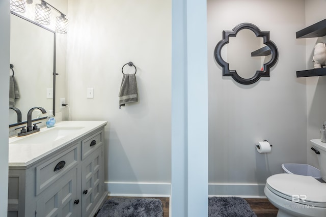 bathroom featuring vanity, toilet, and wood-type flooring