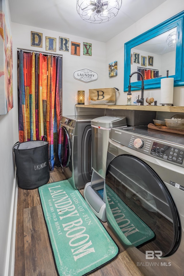 laundry area with independent washer and dryer and dark wood-type flooring