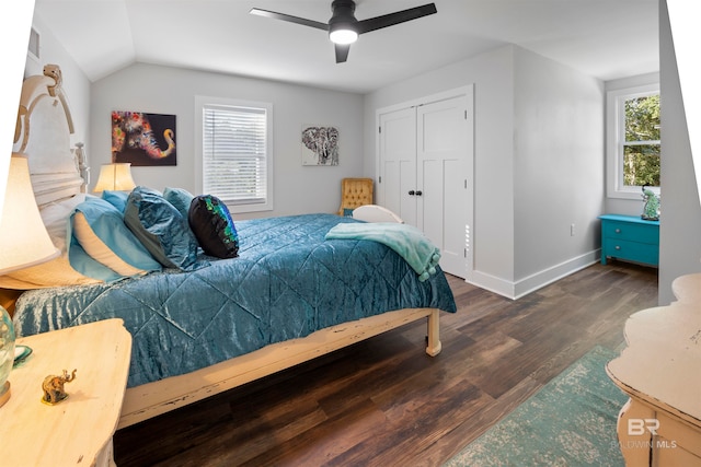 bedroom with lofted ceiling, ceiling fan, a closet, and dark hardwood / wood-style floors