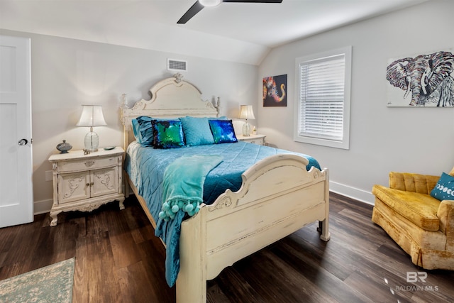 bedroom with dark hardwood / wood-style floors, vaulted ceiling, and ceiling fan