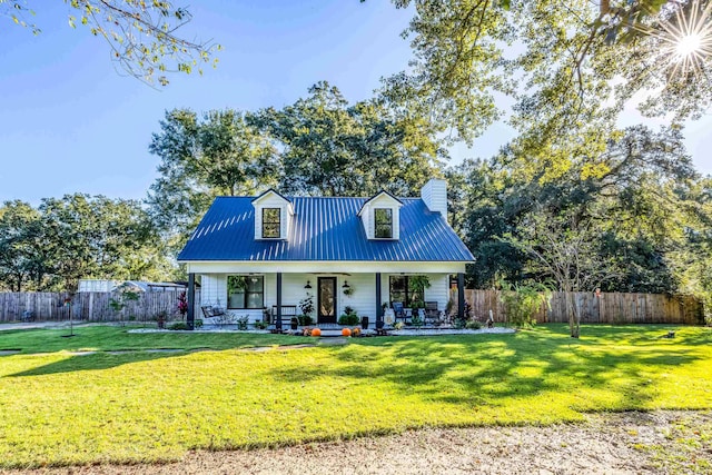 cape cod home with a porch and a front yard