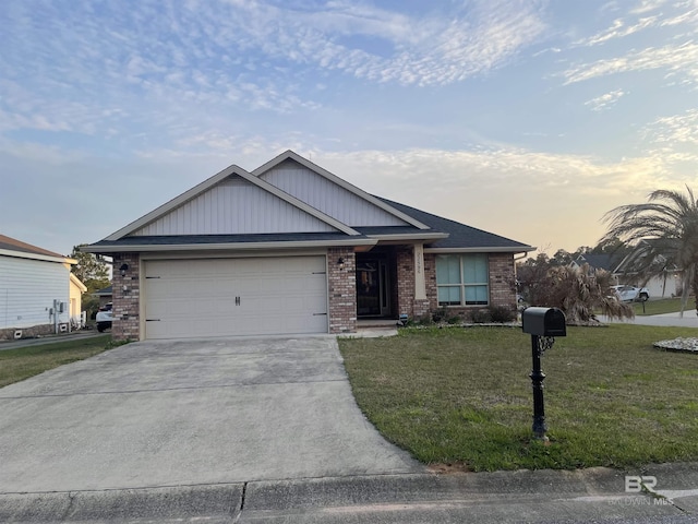 view of front of house with an attached garage, concrete driveway, brick siding, and a front yard