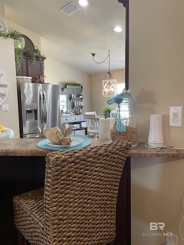 interior space featuring recessed lighting, stainless steel fridge, a sink, and visible vents