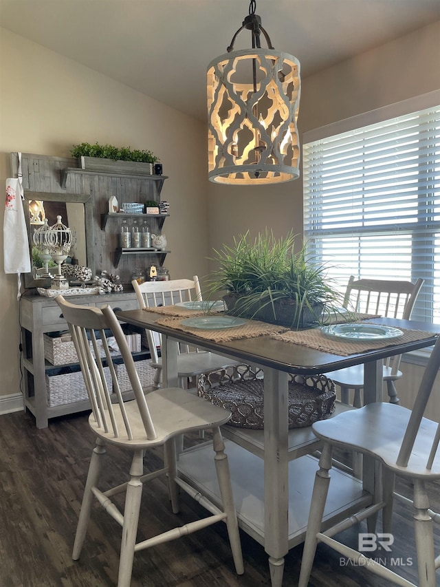 dining space featuring lofted ceiling and wood finished floors