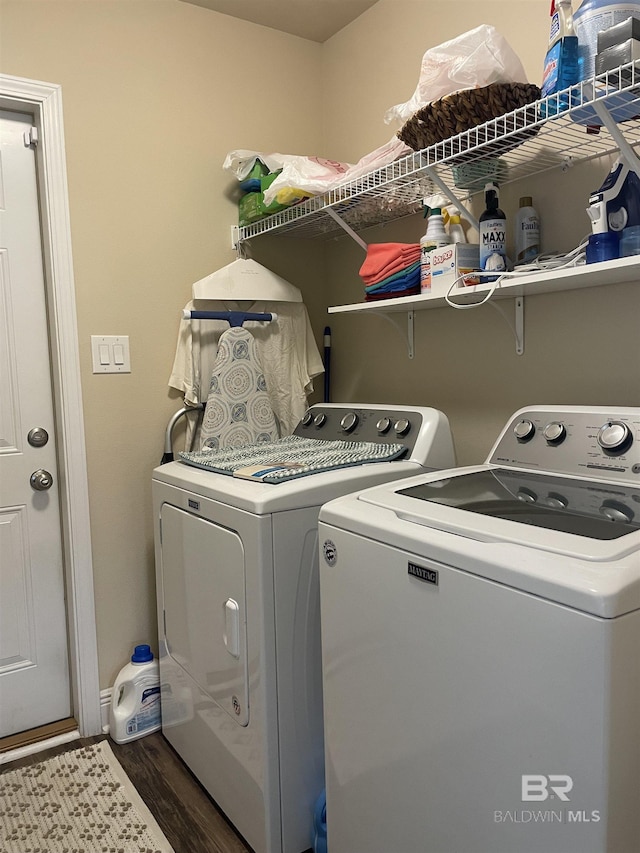 laundry room with washer and dryer, laundry area, dark wood finished floors, and baseboards