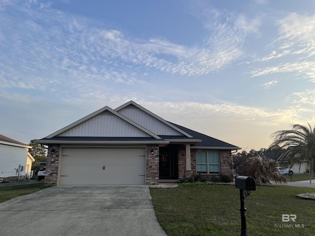 view of front of property with a garage, a front yard, brick siding, and driveway