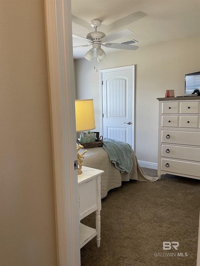 bedroom with dark colored carpet and a ceiling fan