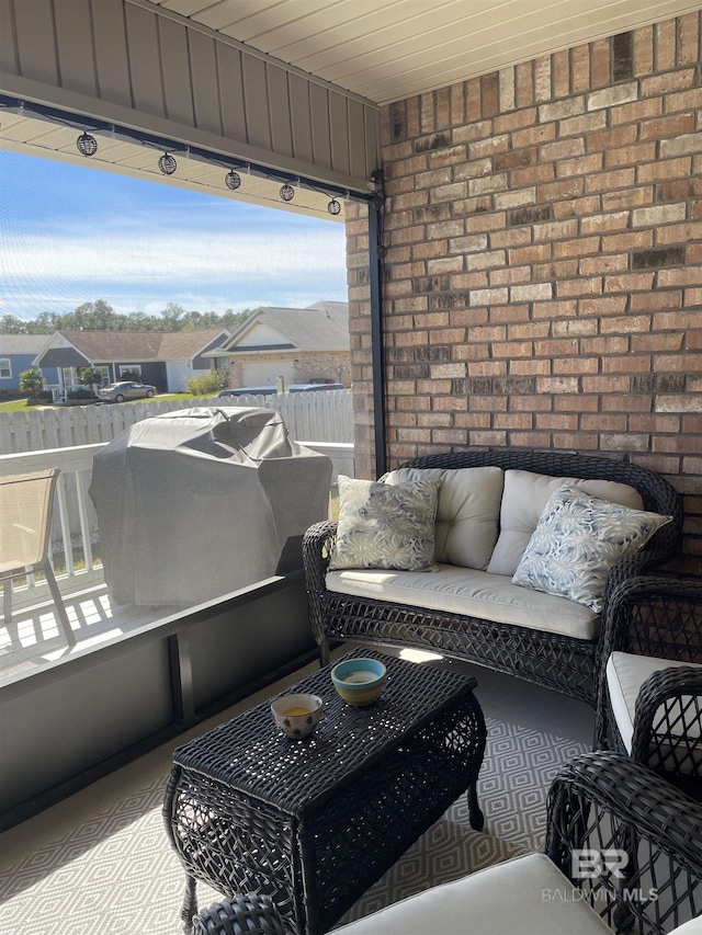 balcony with a residential view, outdoor lounge area, and a grill