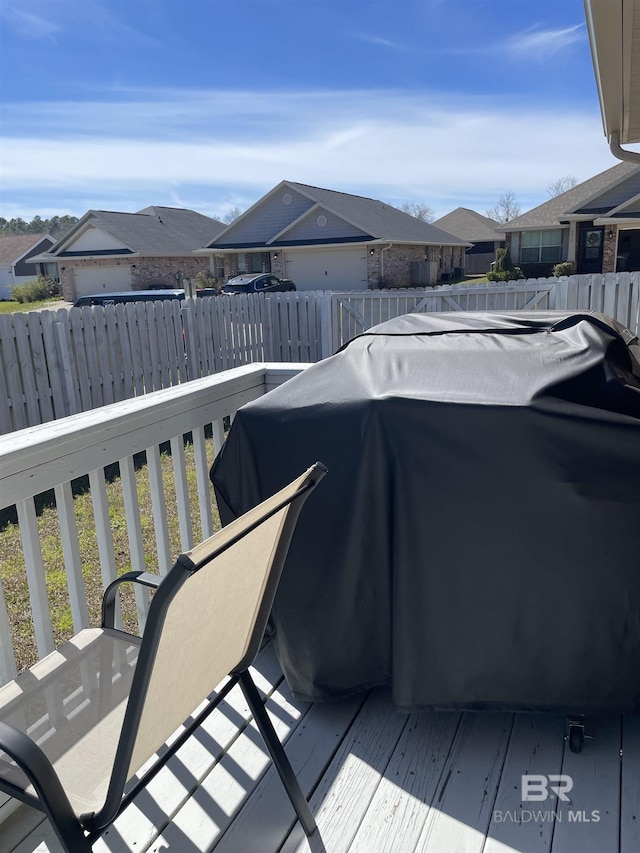 exterior space featuring a residential view, fence, and area for grilling