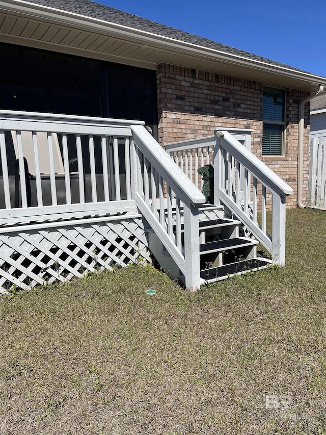 exterior space featuring a lawn and brick siding