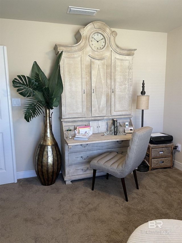 office featuring carpet, visible vents, and baseboards