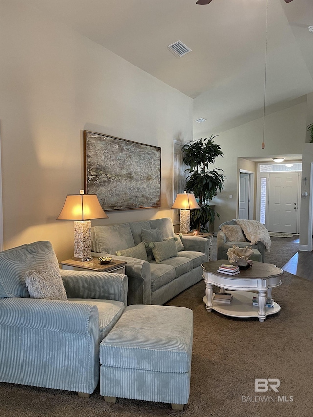 carpeted living room featuring vaulted ceiling and visible vents