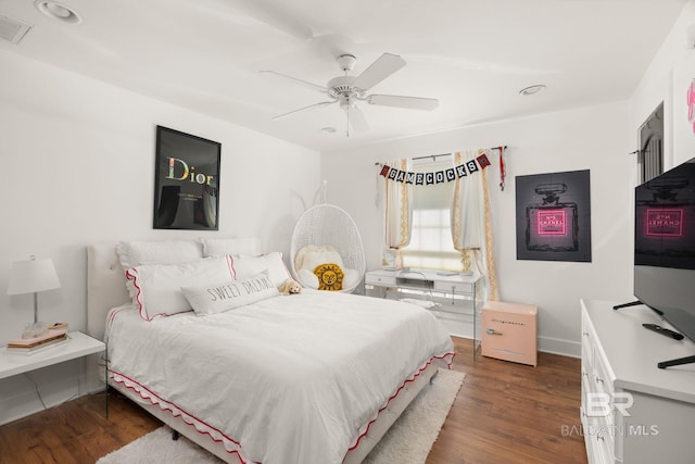 bedroom with dark hardwood / wood-style floors and ceiling fan