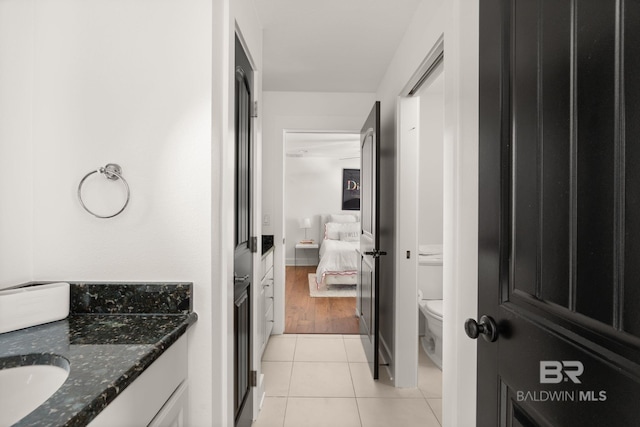 bathroom featuring tile patterned flooring, vanity, and toilet