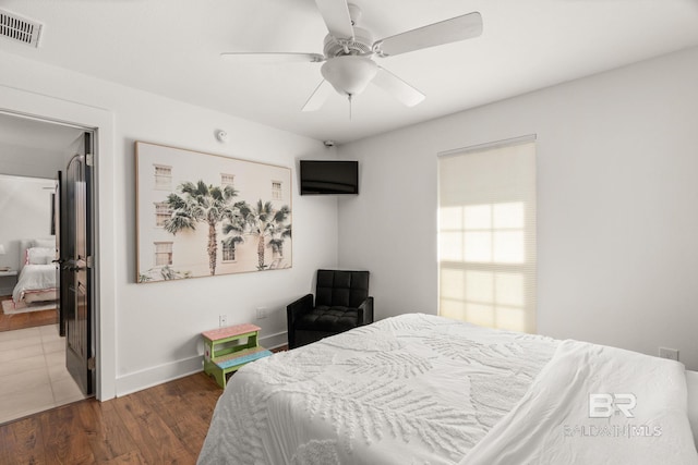 bedroom with dark hardwood / wood-style floors and ceiling fan