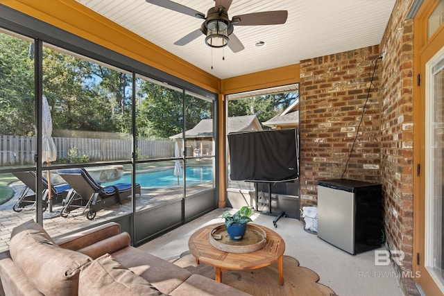 sunroom featuring ceiling fan