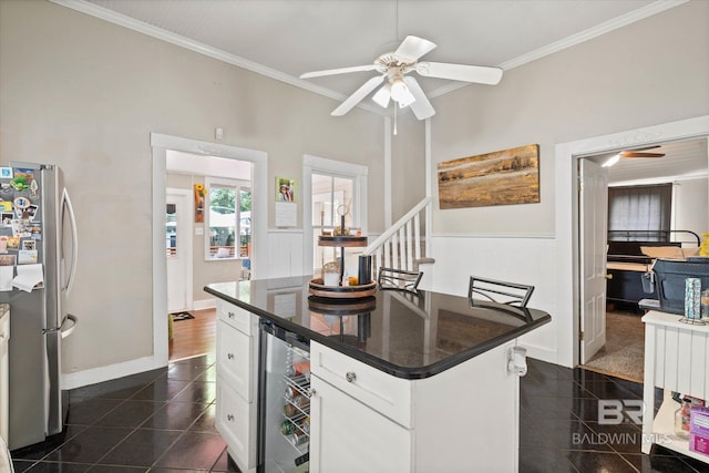 20 Hurlbert St, Mobile, AL 36607 - kitchen with freestanding refrigerator, wine cooler, granite tiled floors, ceiling fan, and crown molding
