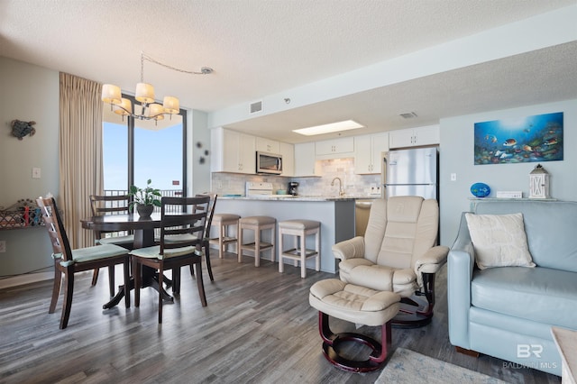 24400 Perdido Beach Blvd Unit 701, Orange Beach, AL 36561 - dining room featuring dark wood-type flooring, a textured ceiling, a notable chandelier, and visible vents