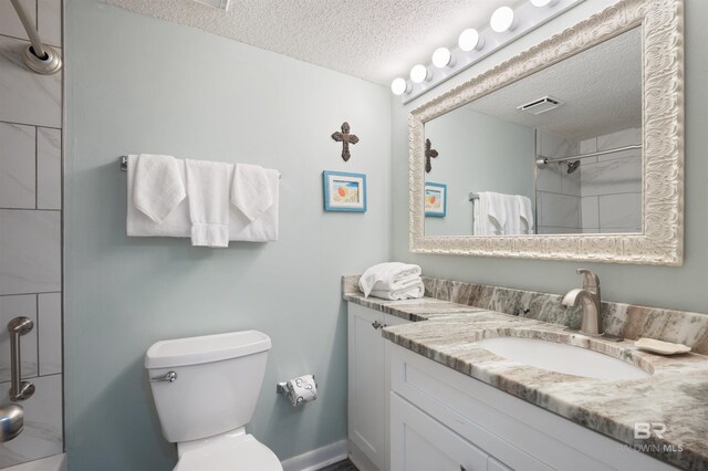 24400 Perdido Beach Blvd Unit 701, Orange Beach, AL 36561 - bathroom featuring visible vents, walk in shower, toilet, a textured ceiling, and vanity