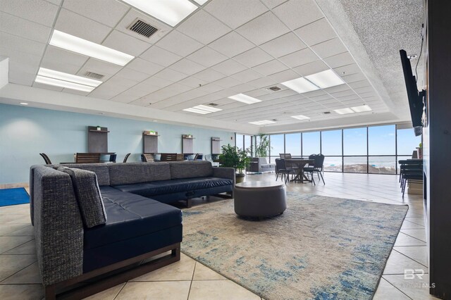 24400 Perdido Beach Blvd Unit 701, Orange Beach, AL 36561 - living room featuring visible vents, tile patterned floors, a tray ceiling, and a drop ceiling