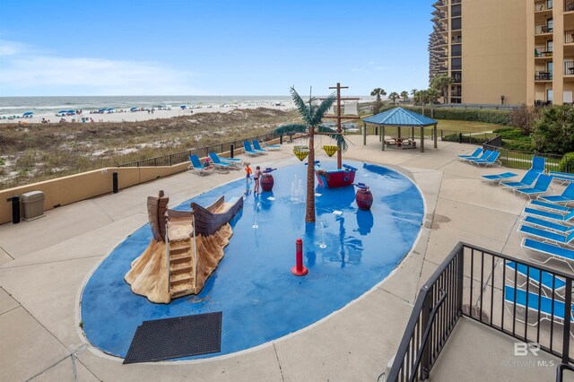 24400 Perdido Beach Blvd Unit 701, Orange Beach, AL 36561 - view of swimming pool featuring a water view, a gazebo, fence, a patio, and a view of the beach