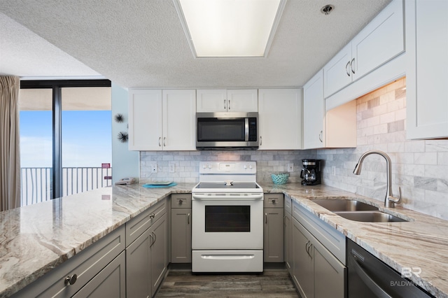 24400 Perdido Beach Blvd Unit 701, Orange Beach, AL 36561 - kitchen with white electric range, gray cabinets, stainless steel microwave, a sink, and dishwasher
