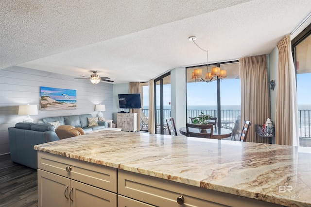 24400 Perdido Beach Blvd Unit 701, Orange Beach, AL 36561 - kitchen with dark wood-style flooring, open floor plan, a textured ceiling, ceiling fan with notable chandelier, and hanging light fixtures
