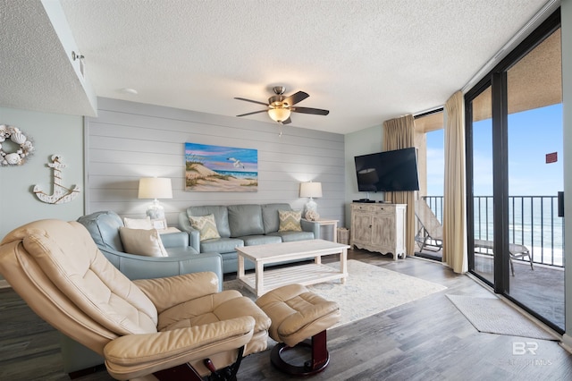 24400 Perdido Beach Blvd Unit 701, Orange Beach, AL 36561 - living area with expansive windows, a textured ceiling, wood finished floors, and ceiling fan