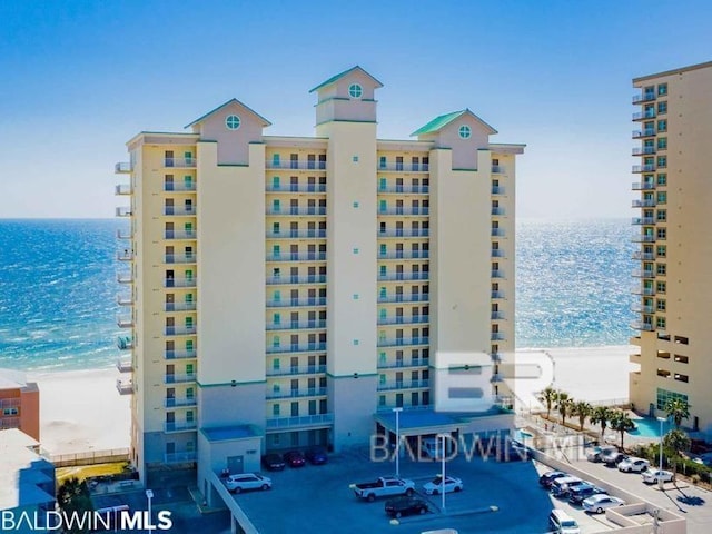 view of property featuring a view of the beach and a water view