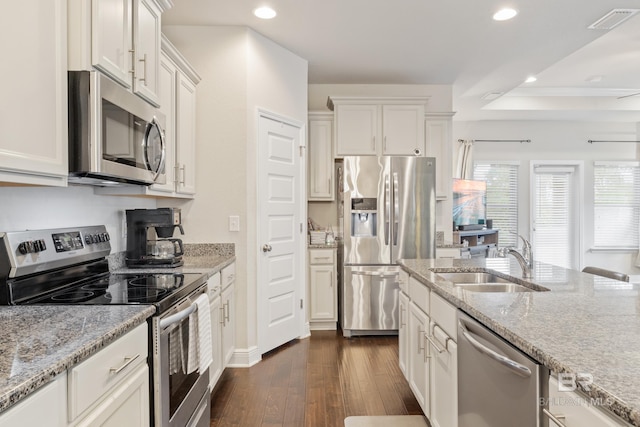 9393 Impala Dr, Foley, AL 36535 - kitchen with visible vents, dark wood-type flooring, a sink, stainless steel appliances, and light stone countertops