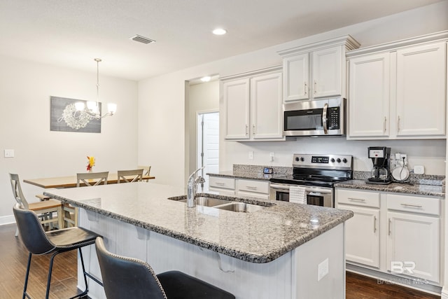 9393 Impala Dr, Foley, AL 36535 - kitchen featuring white cabinetry, dark wood-type flooring, appliances with stainless steel finishes, and a sink