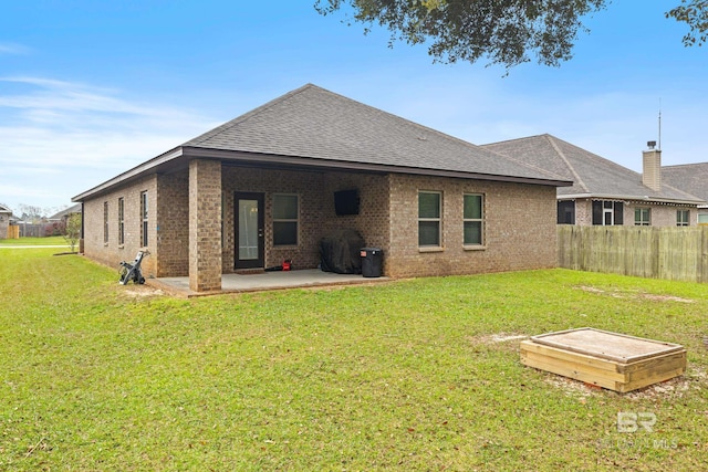 9393 Impala Dr, Foley, AL 36535 - back of property featuring a patio, fence, a shingled roof, a lawn, and brick siding