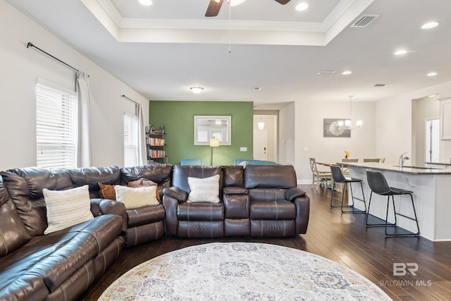 9393 Impala Dr, Foley, AL 36535 - living area featuring visible vents, dark wood-type flooring, recessed lighting, ceiling fan with notable chandelier, and a raised ceiling