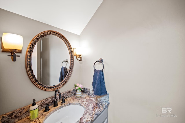 bathroom with vanity and vaulted ceiling