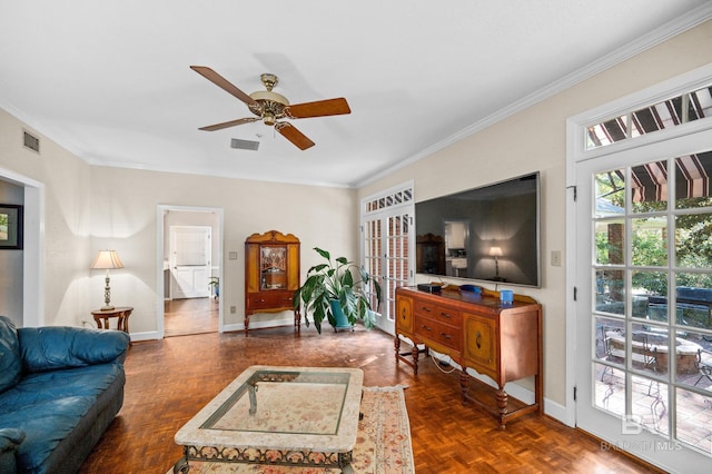 living room featuring ceiling fan, ornamental molding, and dark parquet flooring