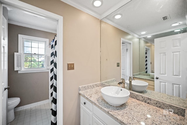 bathroom with vanity, toilet, crown molding, and tile patterned flooring