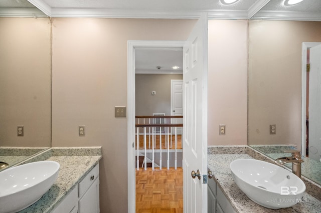 bathroom featuring vanity, crown molding, a textured ceiling, and parquet floors