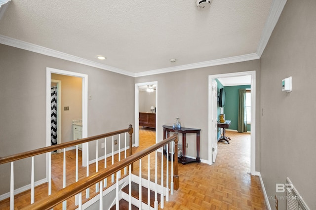 hallway featuring light parquet floors, a textured ceiling, and ornamental molding