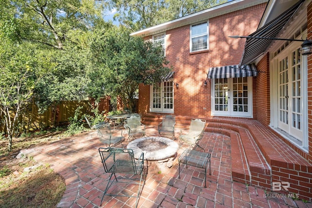 view of patio featuring french doors and an outdoor fire pit