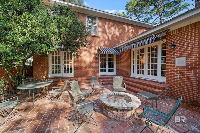 view of patio with french doors and a fire pit