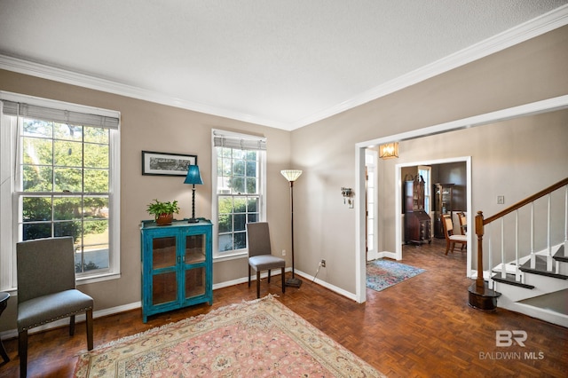 sitting room featuring dark parquet flooring, a healthy amount of sunlight, and a textured ceiling