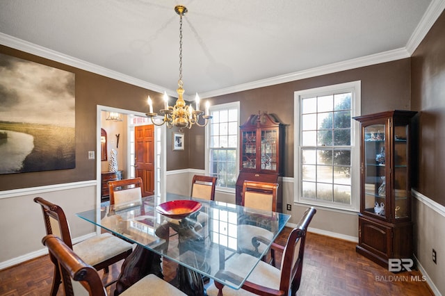 dining space featuring crown molding, a textured ceiling, a chandelier, and dark parquet flooring