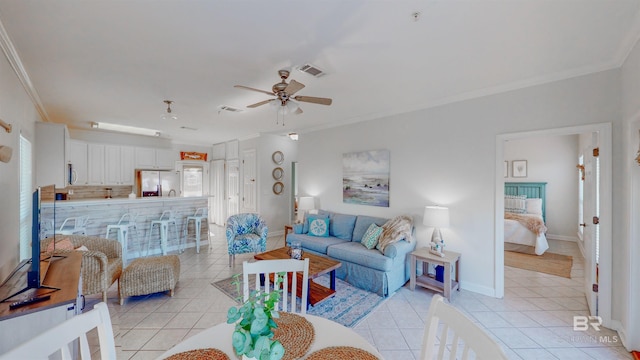 tiled living room featuring crown molding and ceiling fan