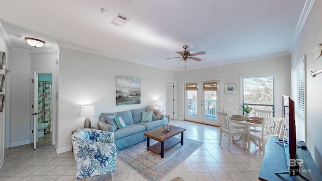 tiled living room with french doors, ceiling fan, and crown molding